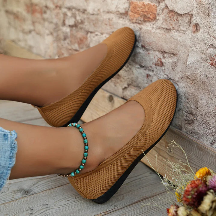 Classic black women's slip-on ballet flats, flexible & comfortable for everyday stylish footwear.