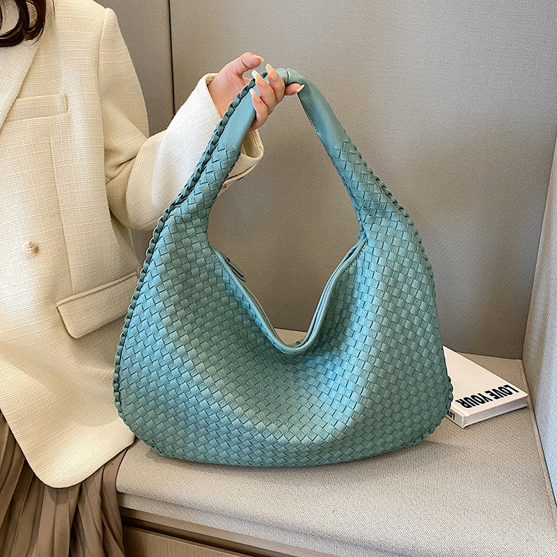 Elegant women's braided hobo bag, a versatile woven leather shoulder bag with bohemian style for any outfit.