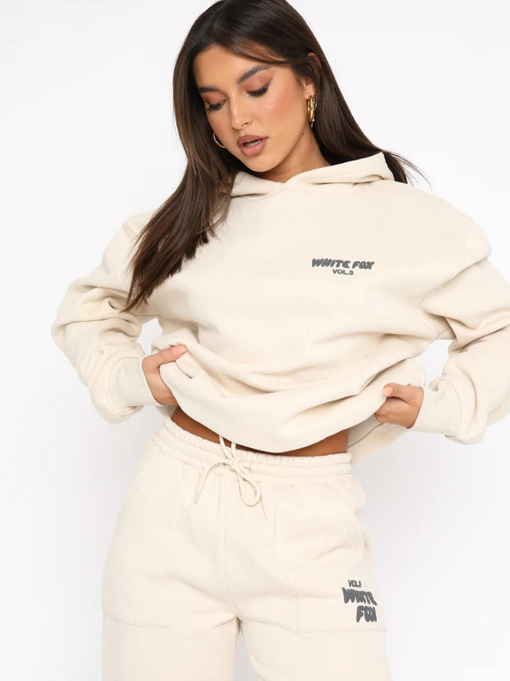 Relaxed fit women's cropped hoodie and joggers tracksuit set. Ideal for casual loungewear and comfort.