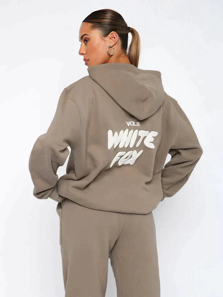 Trendy women's cropped tracksuit set with eye-catching back print. Relaxed fit athleisure for fashion-forward comfort.