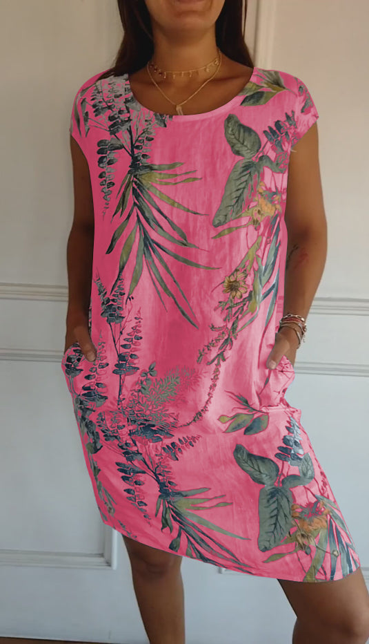 Comfortable women's short sleeve midi dress with a relaxed fit, cheerful leaf print, and convenient patch pockets.