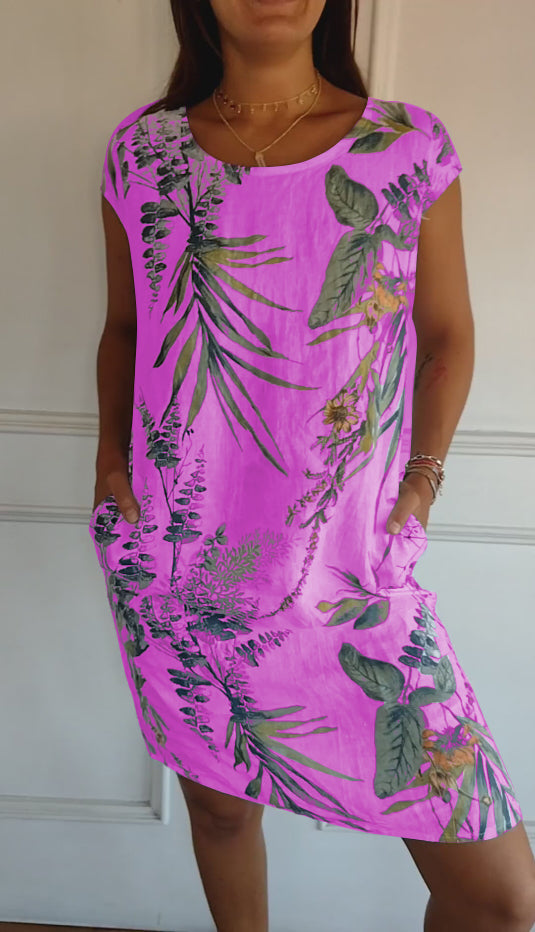 Elegant leaf print midi summer dress for women, featuring a V-neck and practical pockets, ideal for sunny days.