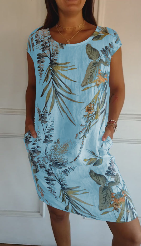 Holiday-ready women's casual midi dress with a vibrant leaf print, V-neck, and practical pockets for relaxed wear.