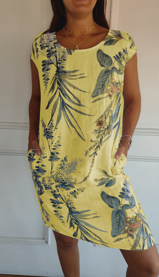 Trendy women's leaf print summer dress, midi length with short sleeves, V-neck, and essential side pockets.