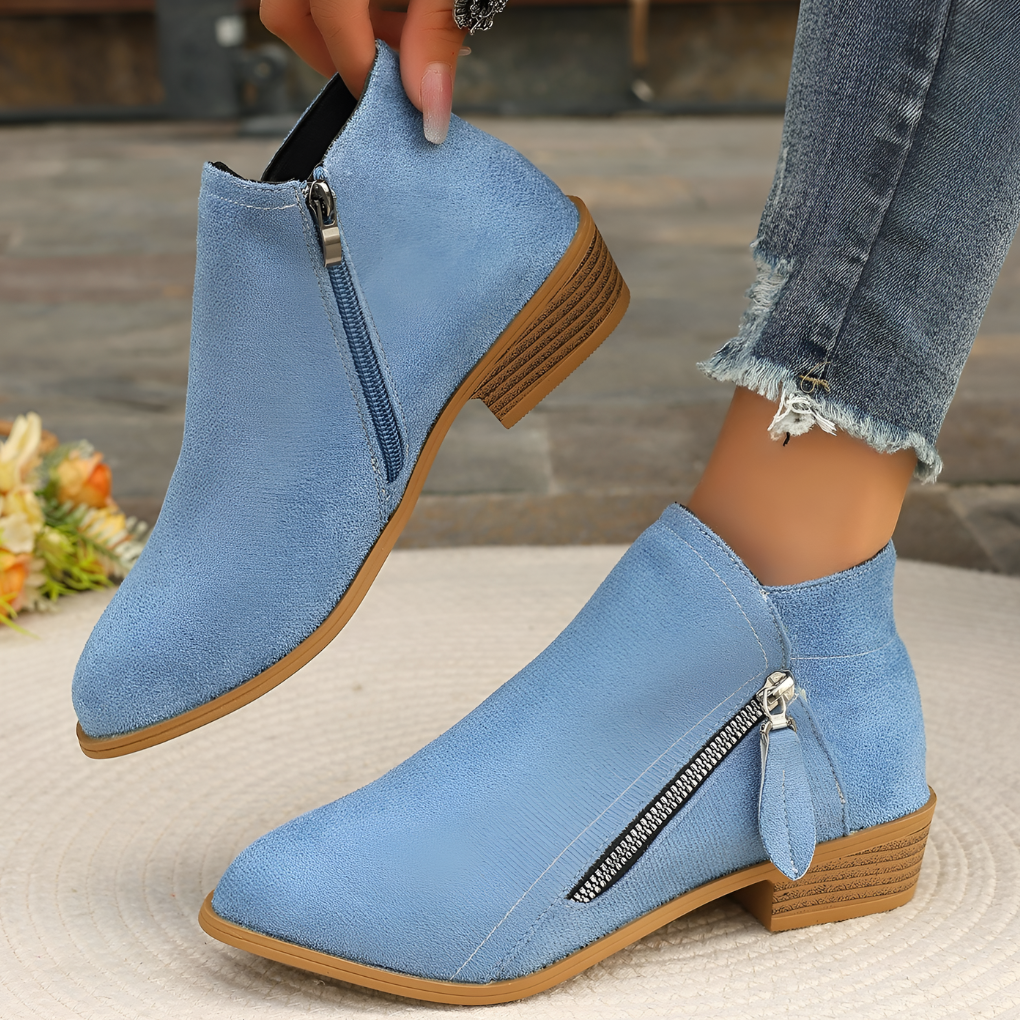Stylish women's black ankle boots featuring a sleek zipper closure & comfortable block heel for any outfit.