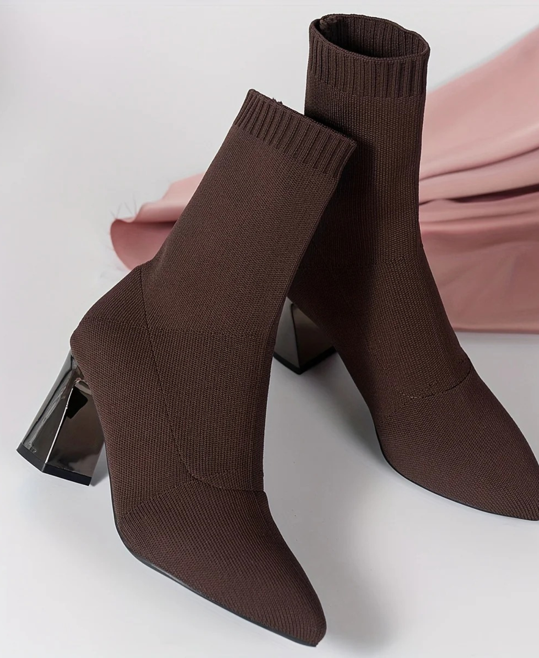 Elegant women's black sock boots featuring a comfortable block heel & sharp pointed toe. Versatile day-to-night footwear.