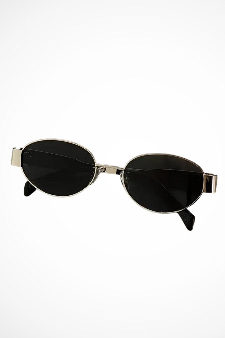 Dark tinted oval metal frame sunglasses for women, offering chic eye protection and a sleek, modern aesthetic.