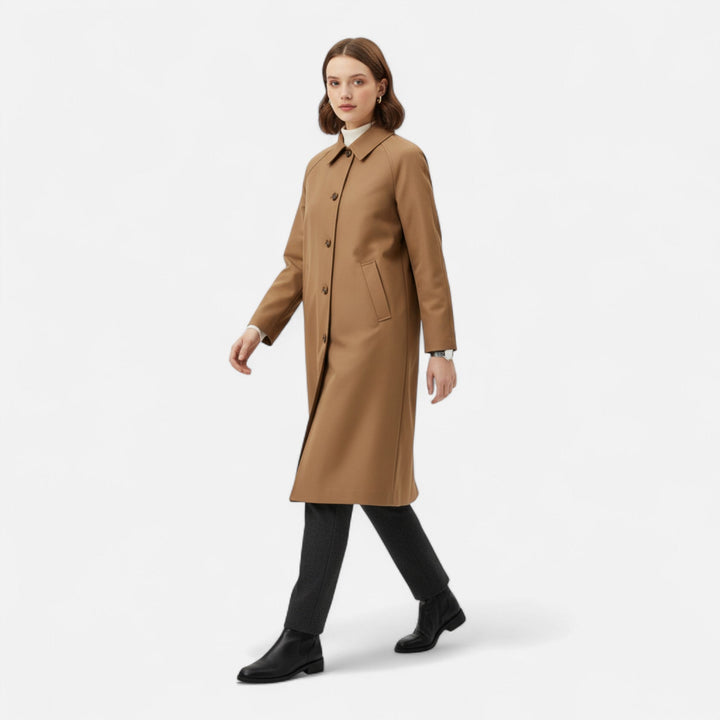 Retro style women's long trench coat. Classic single-breasted outerwear for elegant autumn fashion.