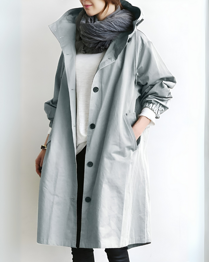 Single-breasted women's classic hooded trench coat. Elegant long sleeve outerwear for autumn and winter fashion.
