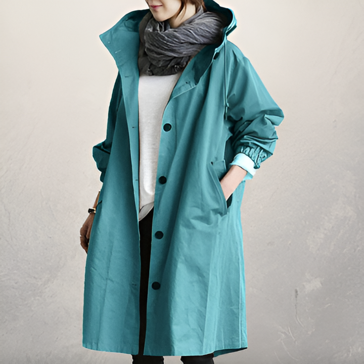 Side view of women's elegant hooded trench coat. Loose fit, long sleeve, stylish outerwear for fall and winter warmth.