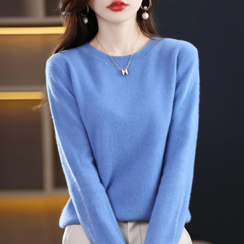 Soft knit women's long sleeve sweater with a classic round neck, comfortable everyday wear.