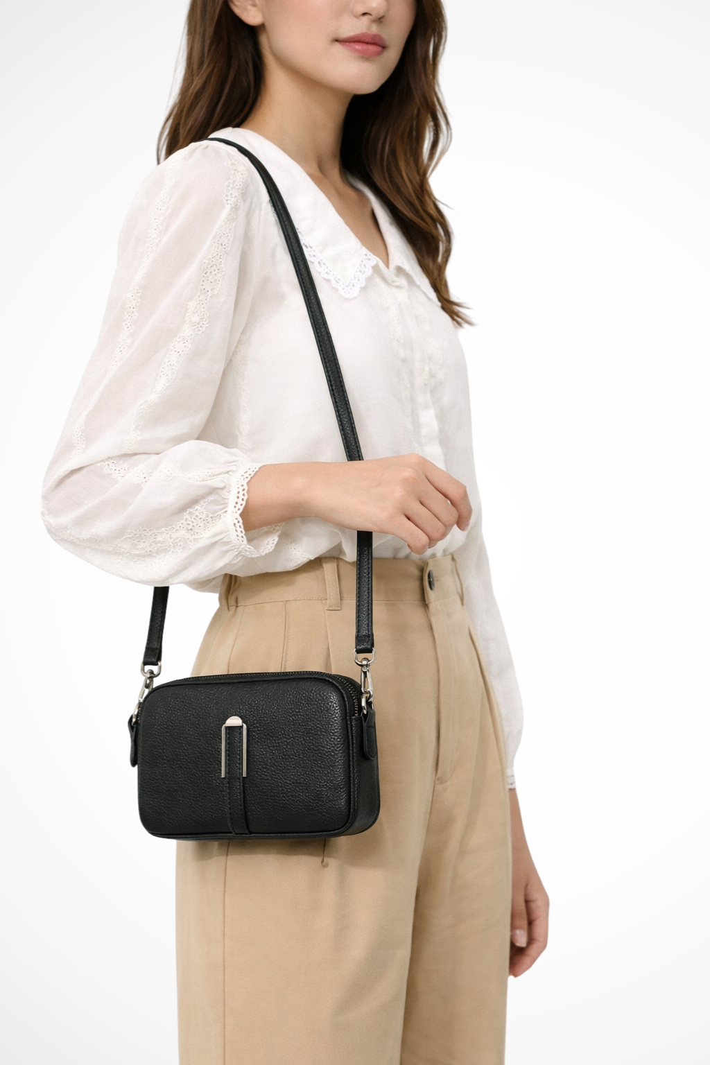 Modern women's compact crossbody bag with dual zip compartments for organized, hands-free wear.