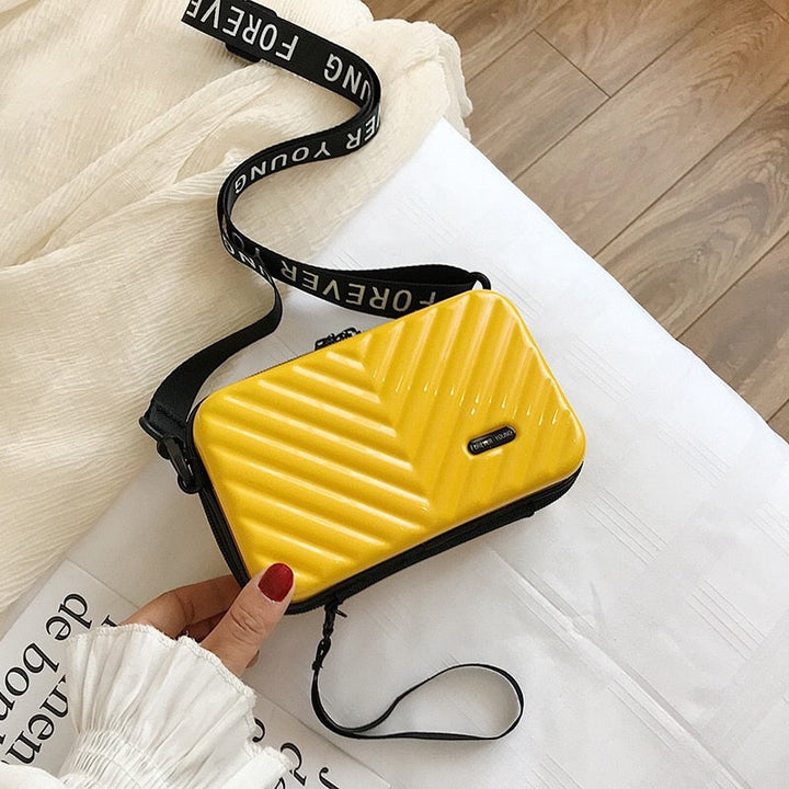 Sleek compact hard shell crossbody bag, modern women's fashion accessory.