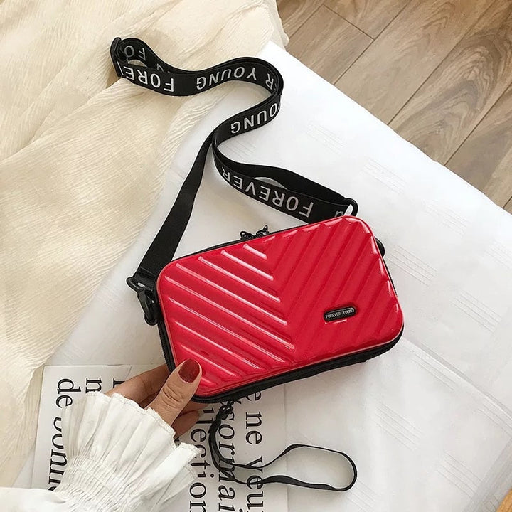 Trendy women's hard shell crossbody mini handbag, a chic fashion accessory for daily carry.