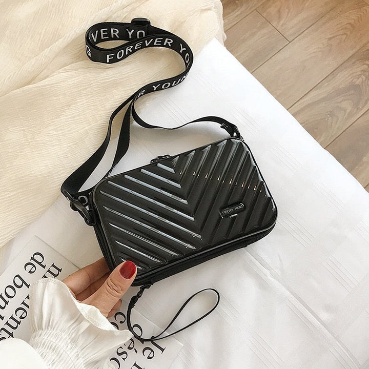 Waterproof PVC hard shell travel crossbody bag for women, durable and stylish.