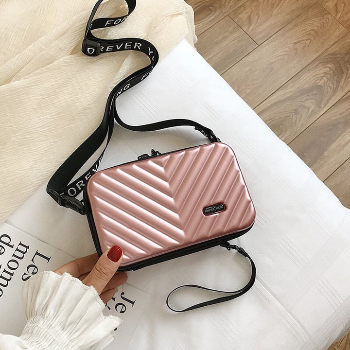 Mini hard shell crossbody travel case, ideal for women's daily essentials & protection.