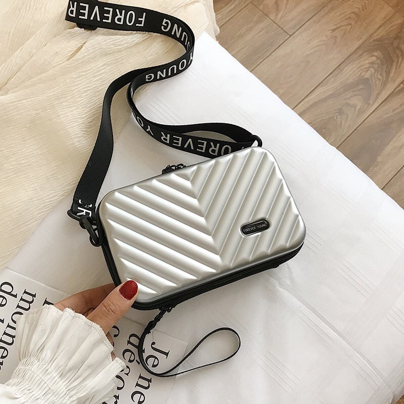 Fashionable women's compact hard shell crossbody handbag, a chic accessory.