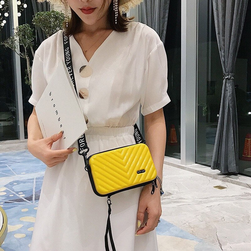 Versatile women's compact hard shell crossbody bag, ideal for travel and daily use.