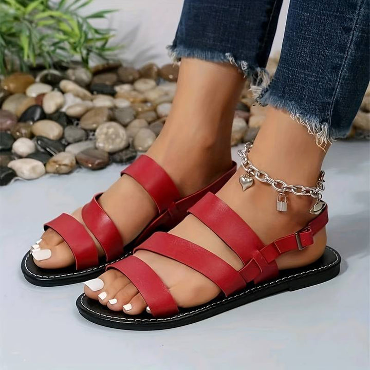 Stylish women's flat sandals with three straps, ideal for summer, beach, or comfortable casual wear. Open-toe design.