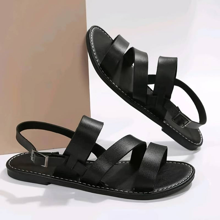 Open-toe women's flat sandals with three stylish straps, offering comfortable and casual summer footwear for any occasion.