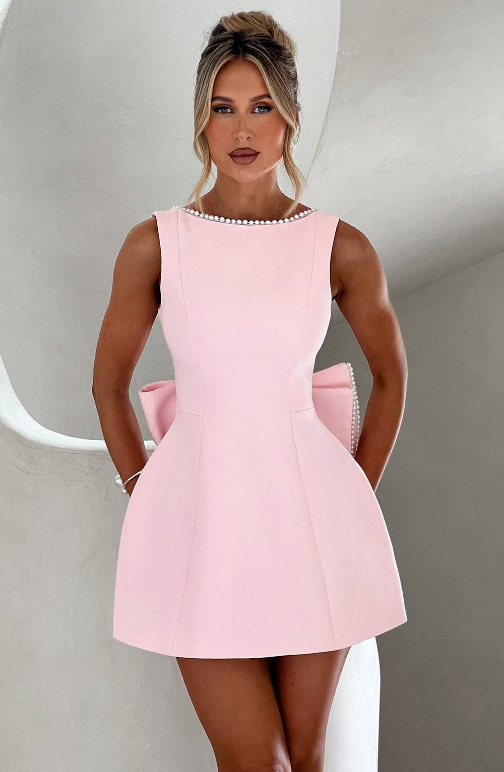 Women's elegant A-line mini dress with pearl trim, perfect for wedding guests and formal parties.