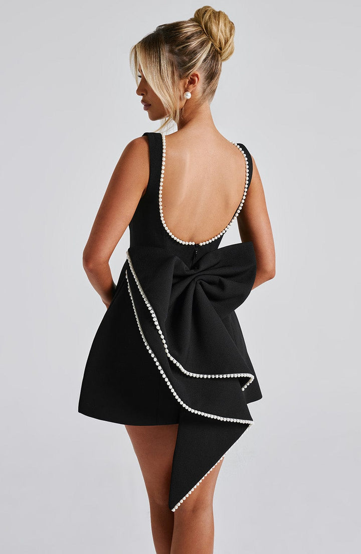 Elegant women's summer A-line mini dress with pearl accents. Comfortable party & wedding guest outfit.