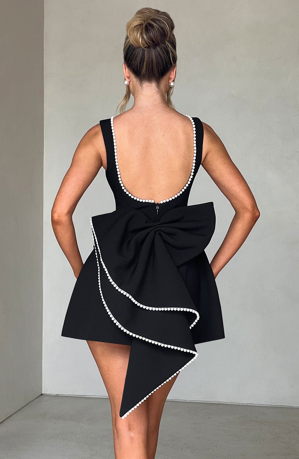 Beautiful women's A-line mini dress featuring pearl trim & bow detail. Perfect for wedding guests.
