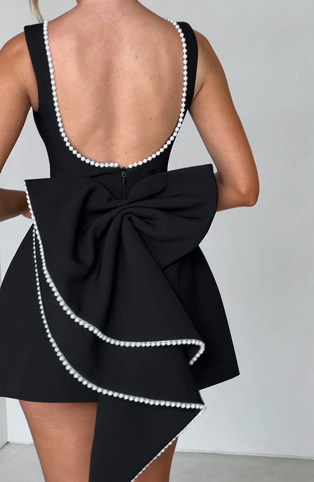 Flowy women's A-line mini dress with luminous pearl trim. Elegant wedding guest, cocktail & party dress.