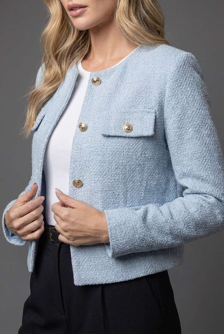 Chic women's cropped jacket featuring striking gold button details. A versatile, elegant blazer for spring workwear.