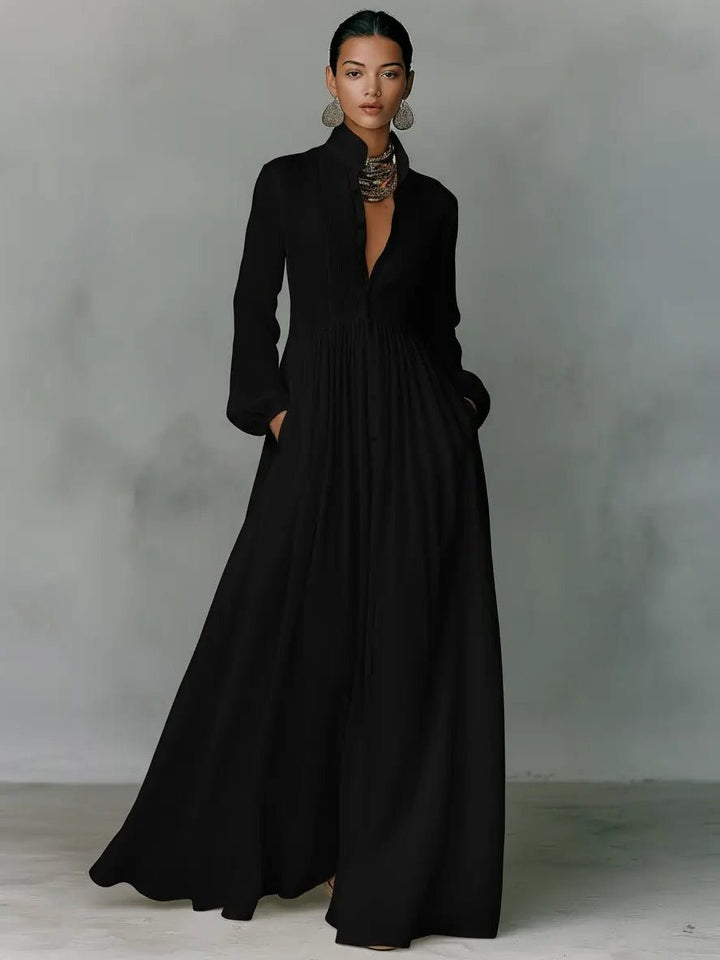 Close-up of a women's maxi shirt dress showing the stylish stand collar, button-front detail, & functional pockets.