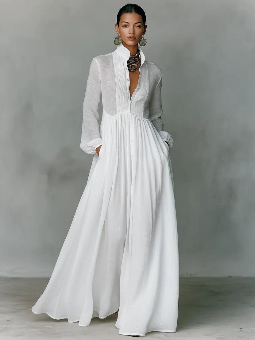 Woman wearing a flowing maxi shirt dress with stand collar & pockets, showcasing its comfortable & elegant casual style.