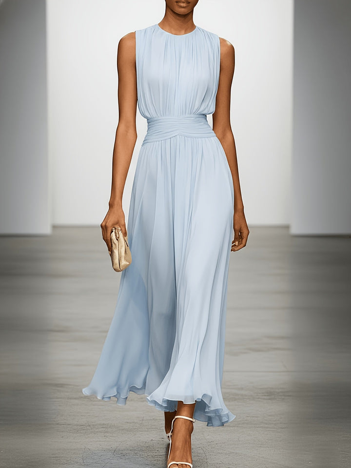 Sleeveless pleated maxi dress for wedding guests. Features a stylish ruched waist & elegant summer style.