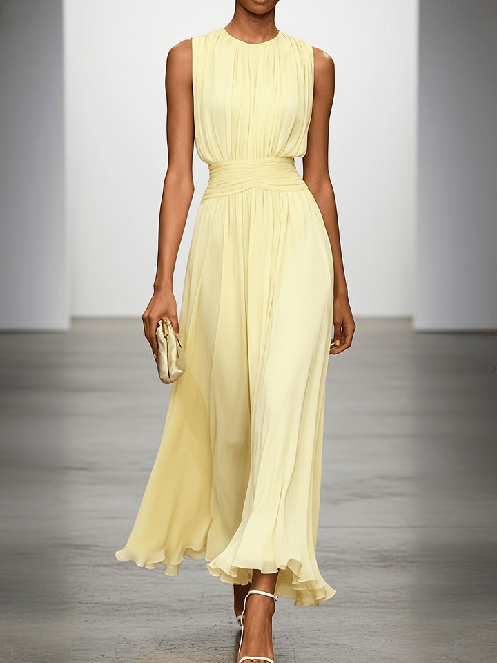 Elegant women's pleated maxi dress with a flattering ruched waist, suitable for wedding guest attire.