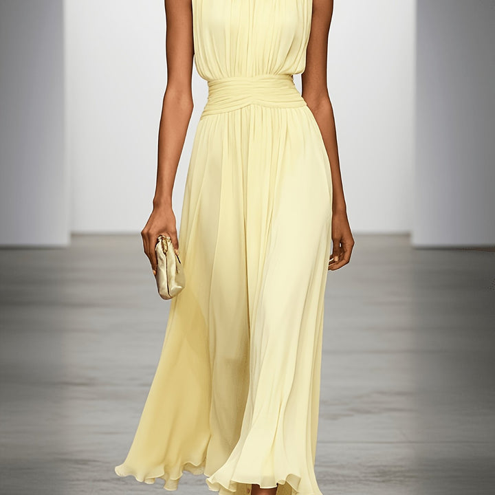Sleek sleeveless long dress, pleated design, with a chic ruched waist for elegant wedding guest fashion.