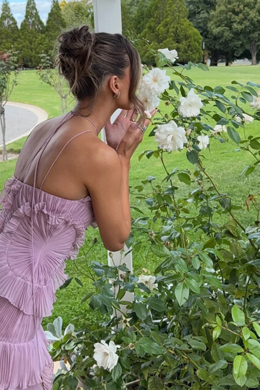 Elegant women's party dress: ruffled halter maxi with backless design & pleated details. Summer fashion.