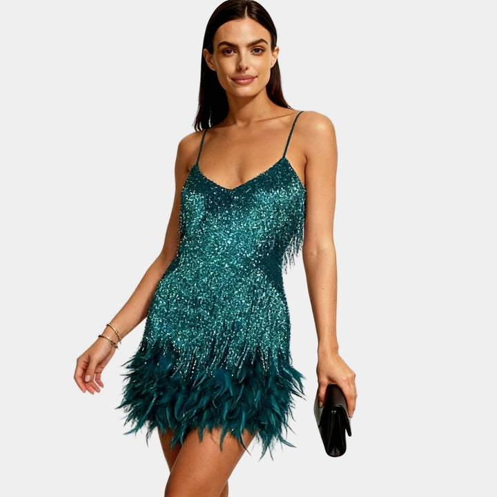 Elegant women's spaghetti strap sequin mini dress featuring playful feather details for parties.