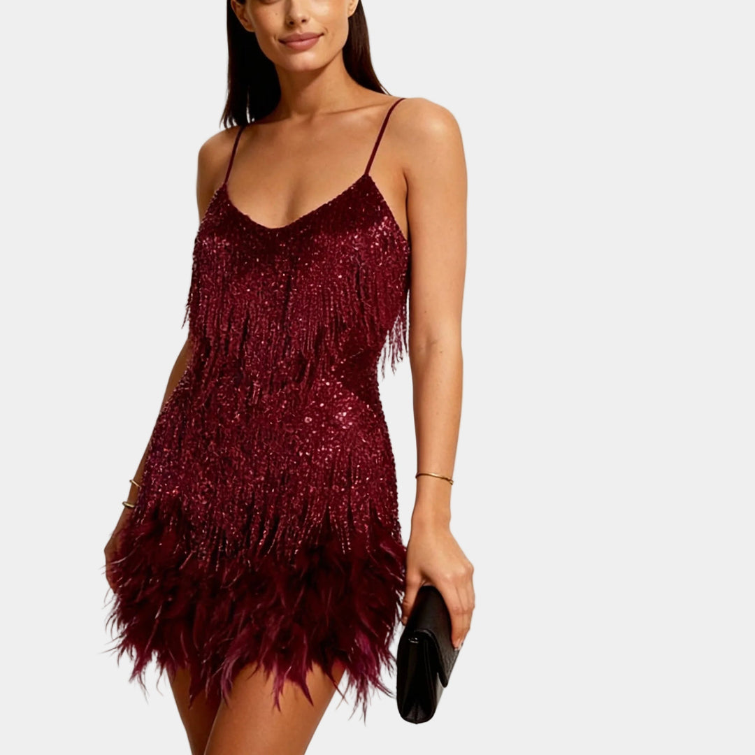 Shimmering women's sequin mini dress adorned with soft feather trim, a perfect night out outfit.