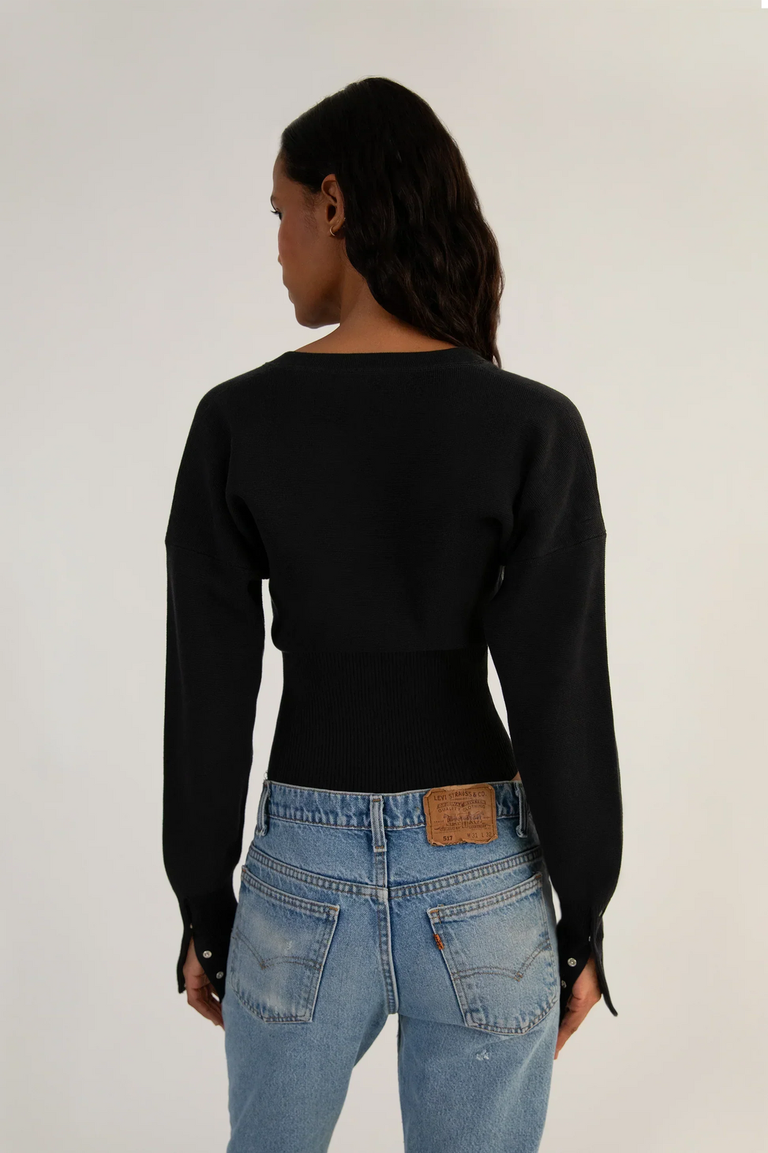 Modern women's cropped knit cardigan, fitted and button-up, a stylish and versatile layering piece.