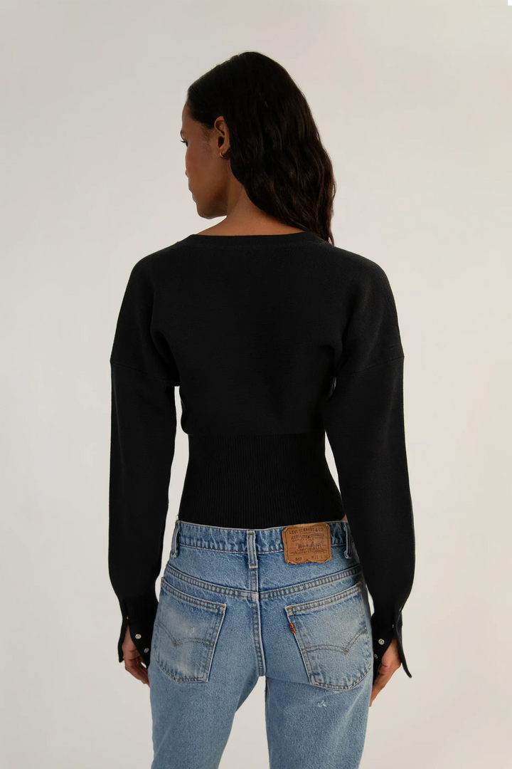 Modern women's cropped knit cardigan, fitted and button-up, a stylish and versatile layering piece.