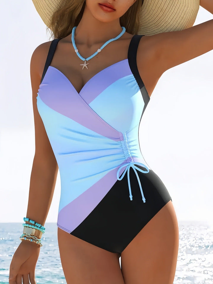 Women's elegant one-piece swimsuit, featuring a timeless striped design & adjustable straps for vacation wear.
