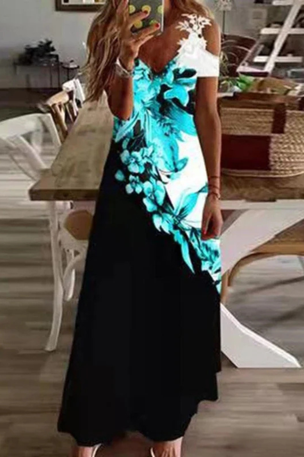 Back view of a flowing women's floral cold-shoulder maxi dress, summer fashion.
