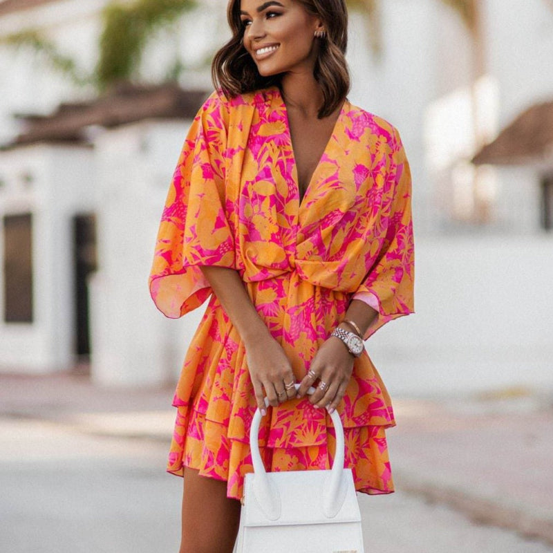 Women's floral mini summer dress with ruffle hem, V-neck, and boho style for casual daywear or holiday outfit.