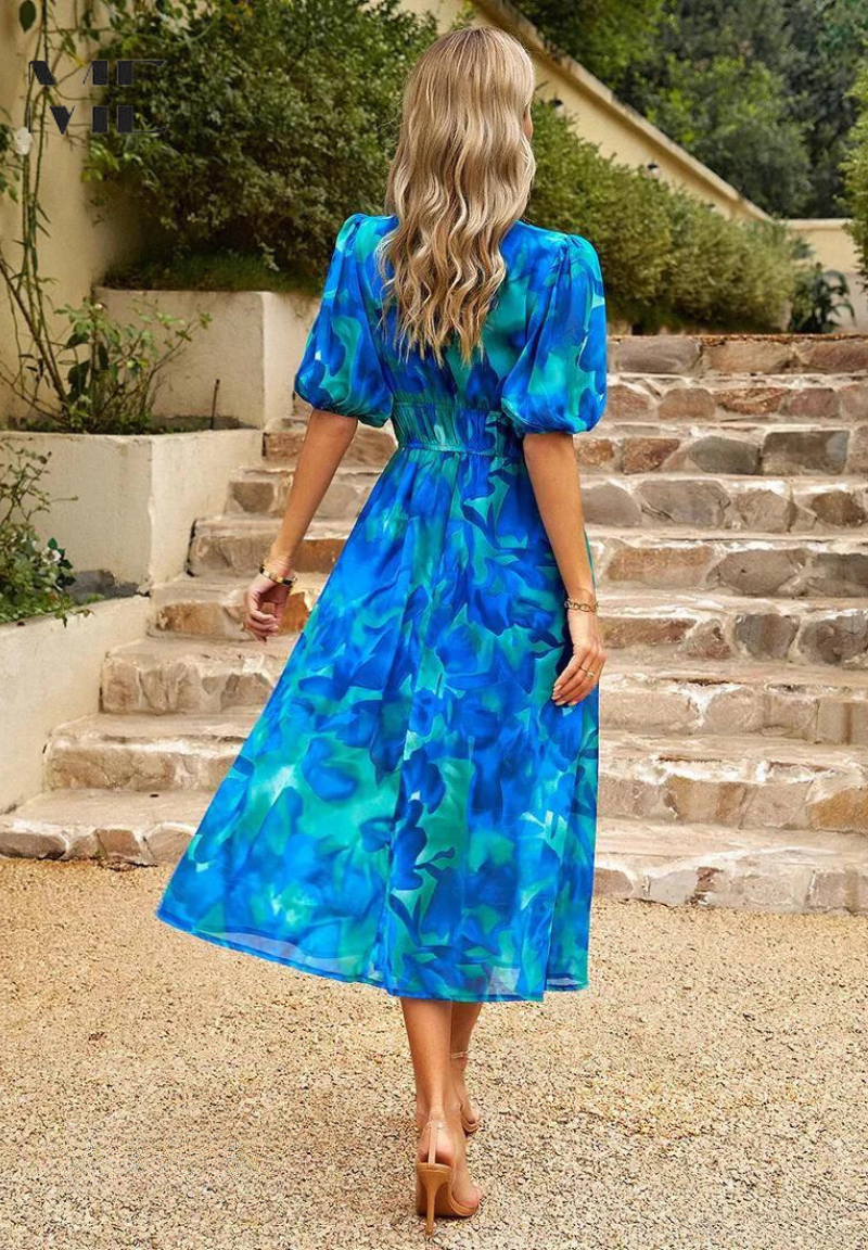 Sophisticated women's floral summer dress, midi length, with puff sleeves and V-neckline.