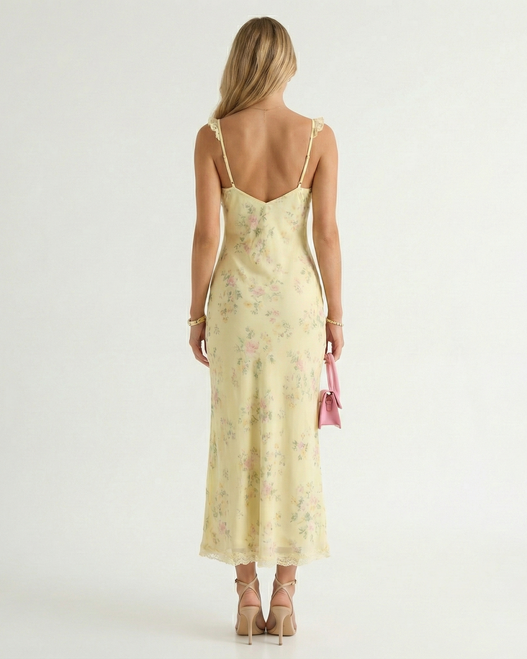 Elegant backless floral midi dress for women. Ideal summer vacation, resort wear. Features a delicate spaghetti strap.