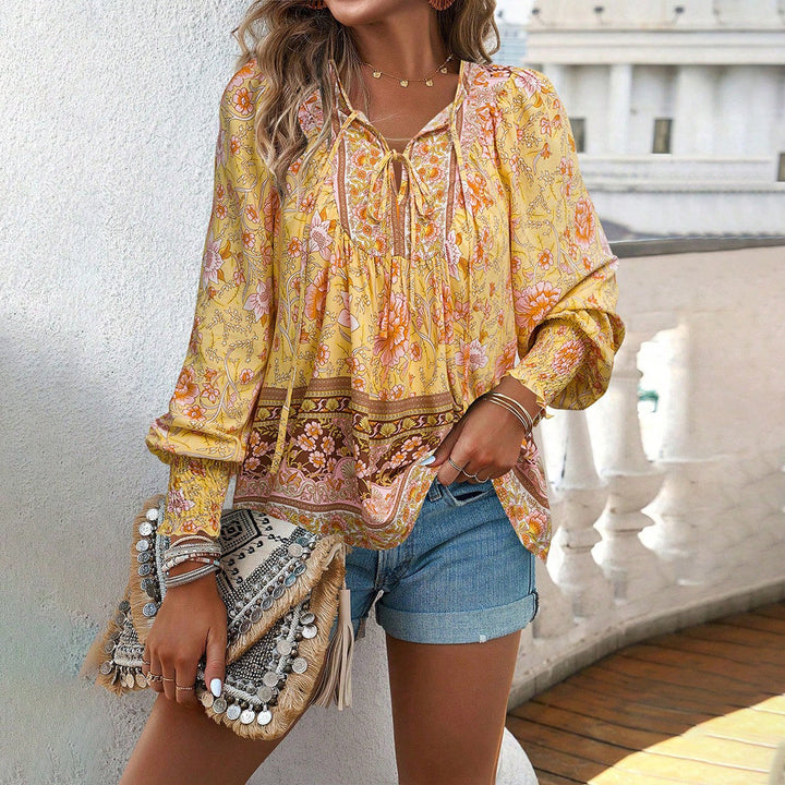 Stylish women's floral tie-front long sleeve blouse. Perfect casual top for versatile everyday wear.