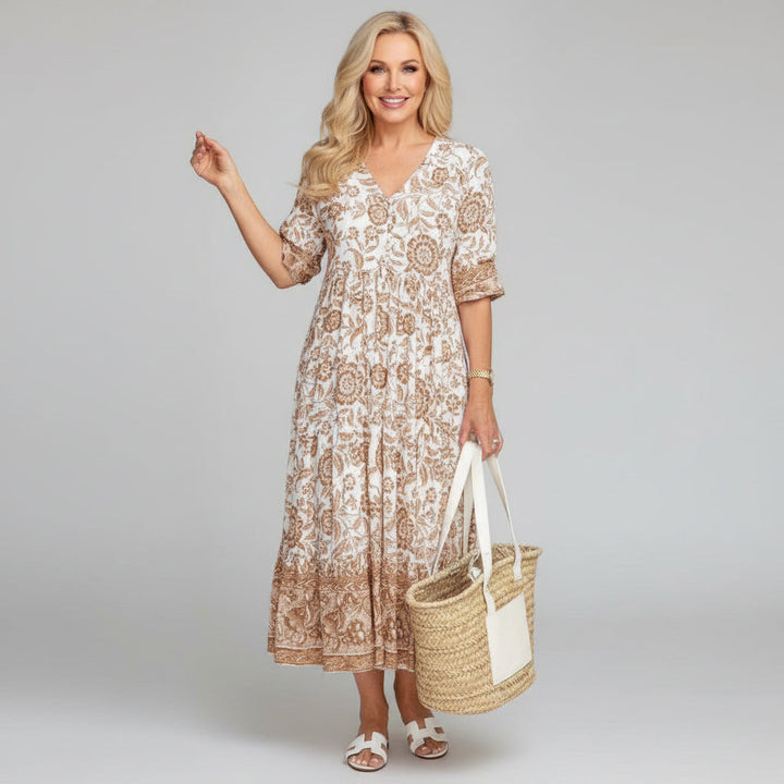 Elegant women's floral A-line midi dress. Flowy tiered design, V-neck, 3/4 sleeves. Ideal for summer events.