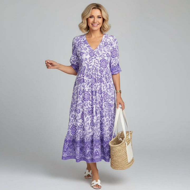 Feminine casual floral tiered midi dress for women. V-neck, 3/4 sleeves. Great for summer holidays & relaxed style.