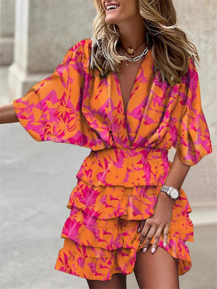 Spring/summer casual women's mini dress with vibrant floral print, V-neck, ruffles & flowy batwing sleeves.