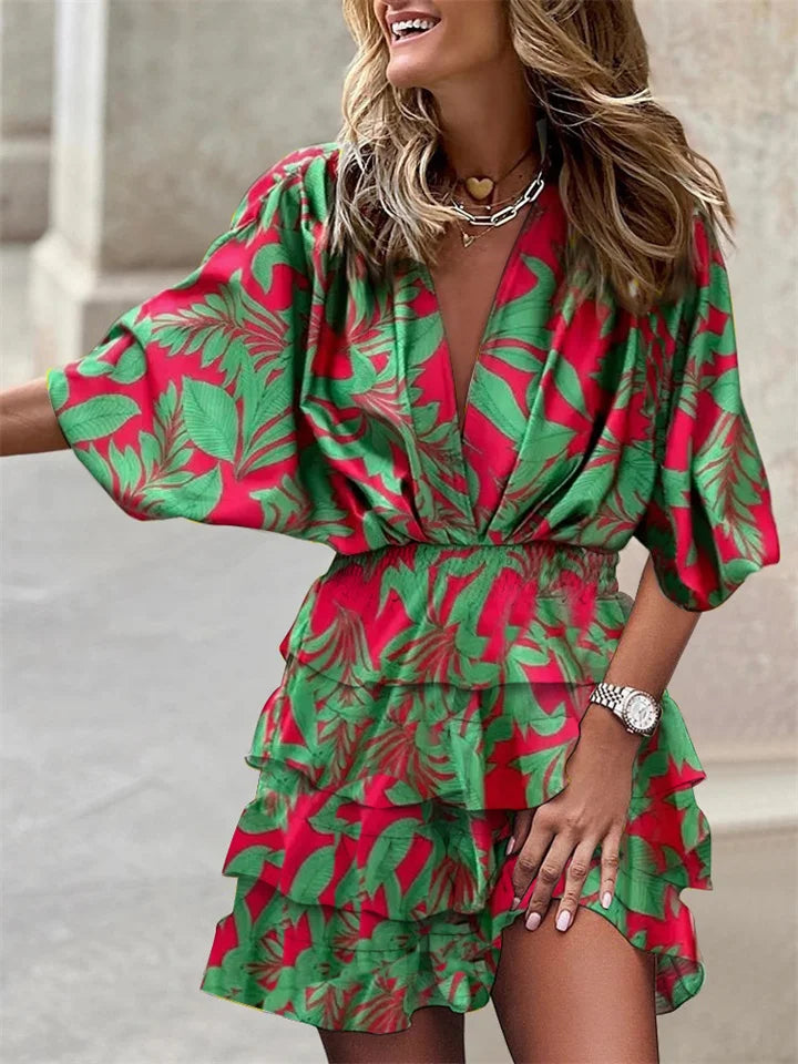 Stylish women's mini dress: V-neck floral design, playful ruffles & distinct batwing sleeves for comfort.