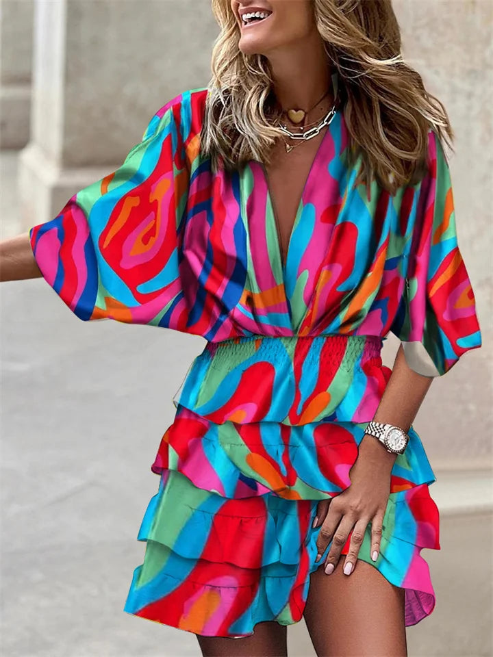 Comfortable women's floral V-neck mini dress featuring fashionable ruffles & relaxed batwing sleeves.